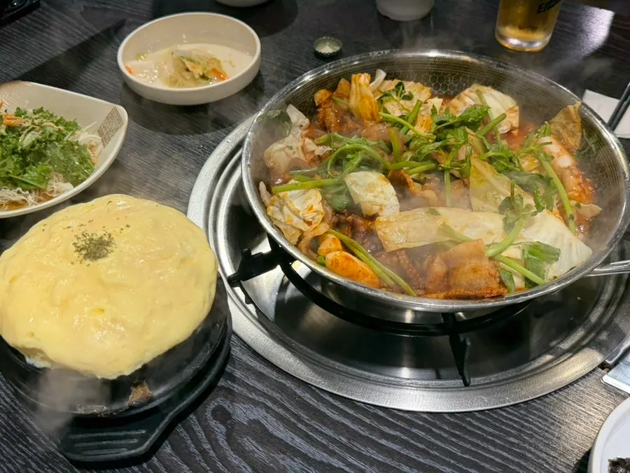 Full table spread with jjukkumi, steamed egg, and side dishes