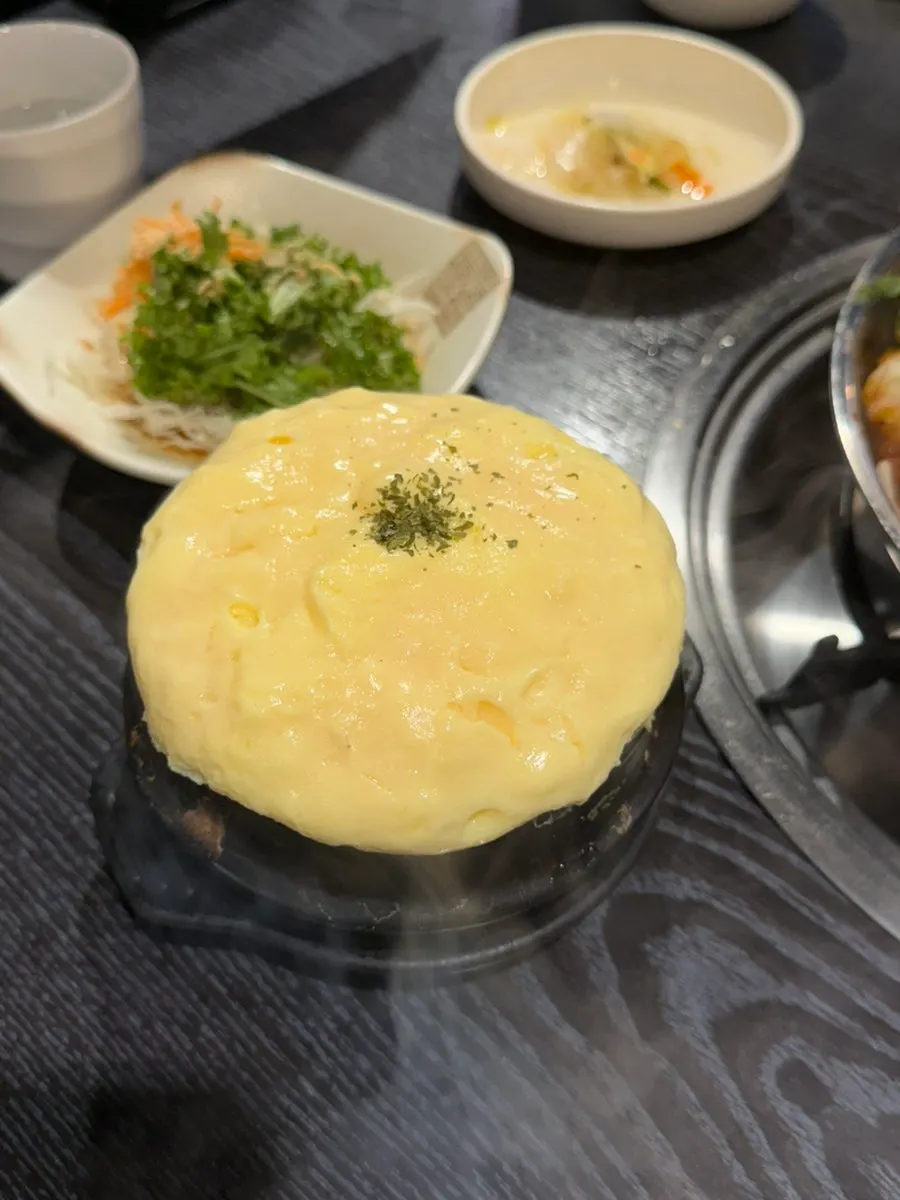 A bite of jjukkumi and pork belly wrapped in seaweed