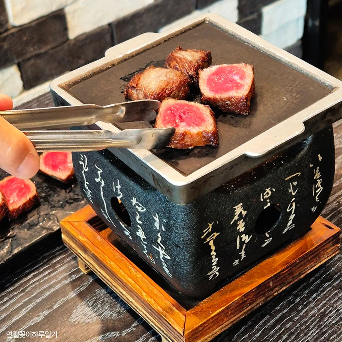 Pre-seared hanwoo sirloin arranged on a stone plate