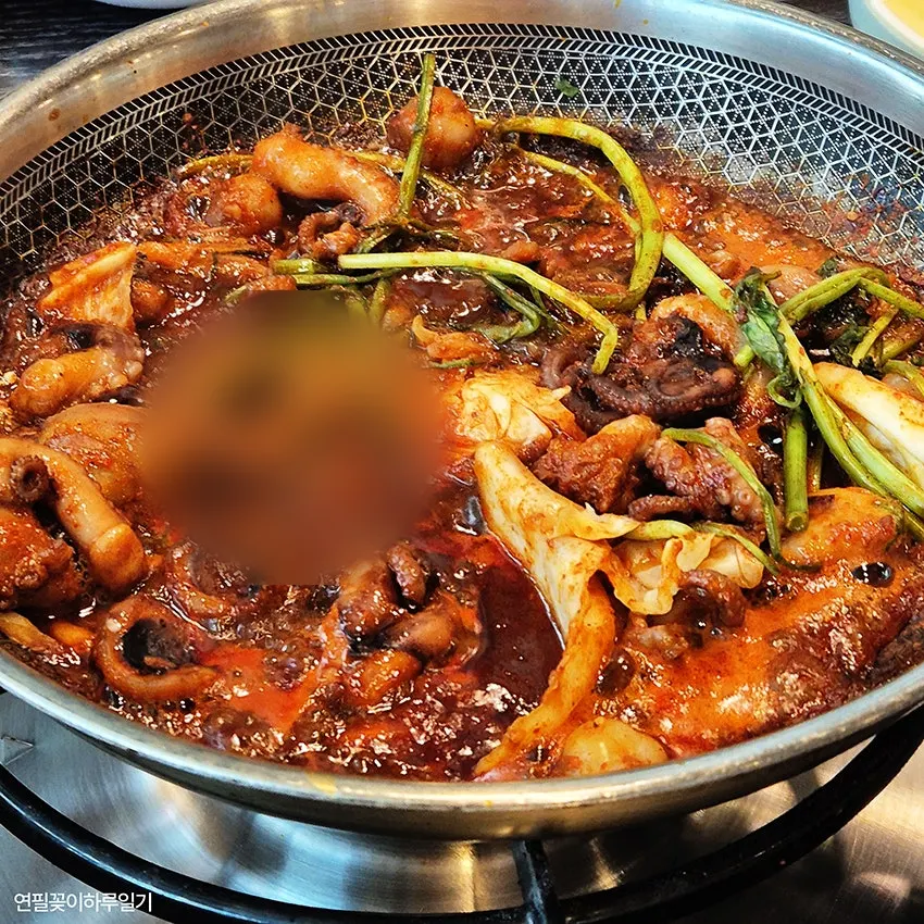Full spread of octopus dish with wrap side dishes