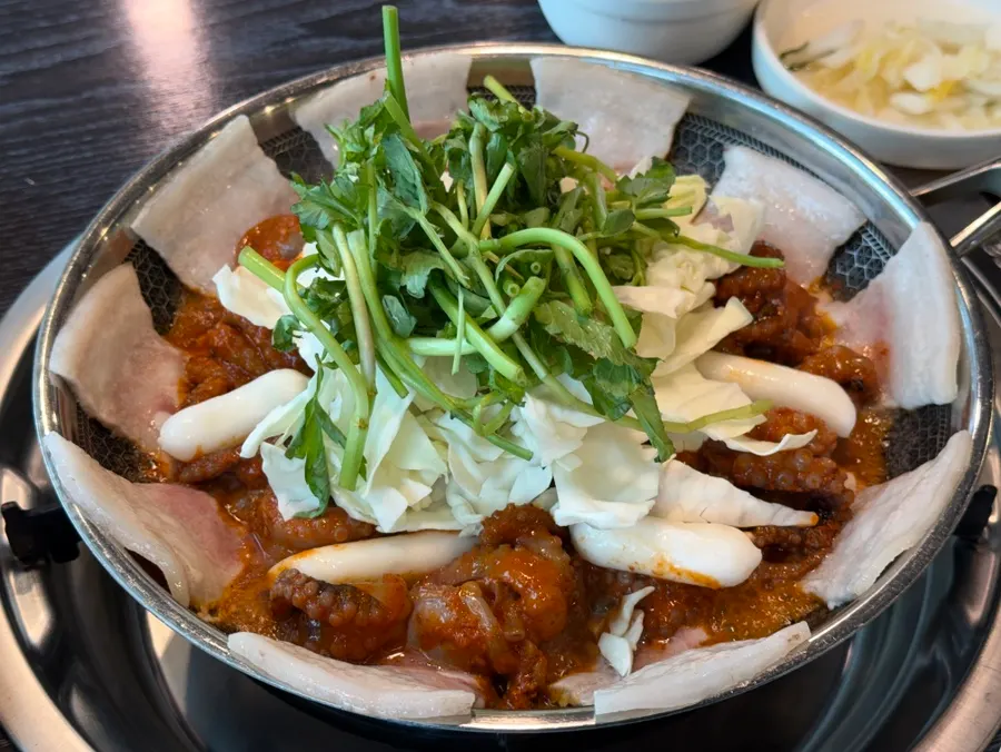 Close-up of the octopus and pork belly pan as it cooks