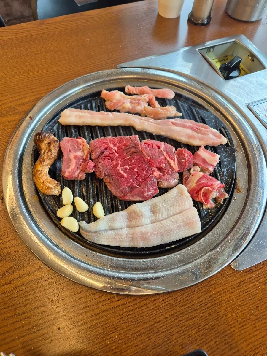 불판에서 함께 익는 소고기와 닭목살