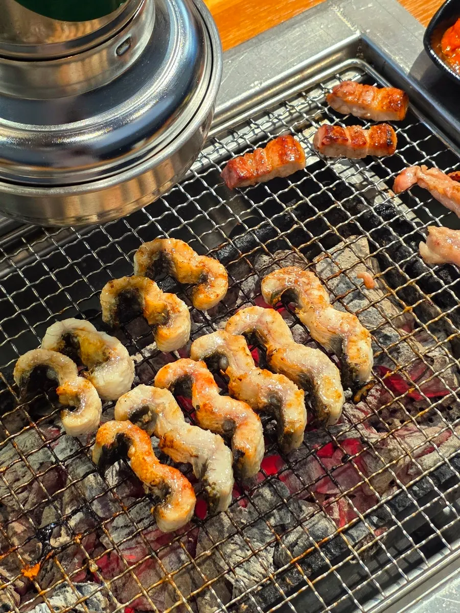 Eel topped with ginger strips dipped in sauce