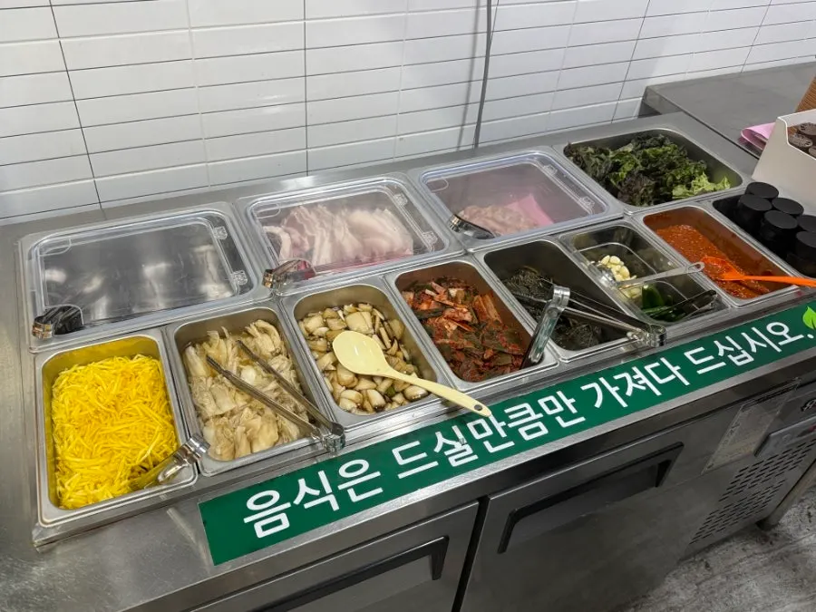 Menu board showing the adult all-you-can-eat and takeout prices