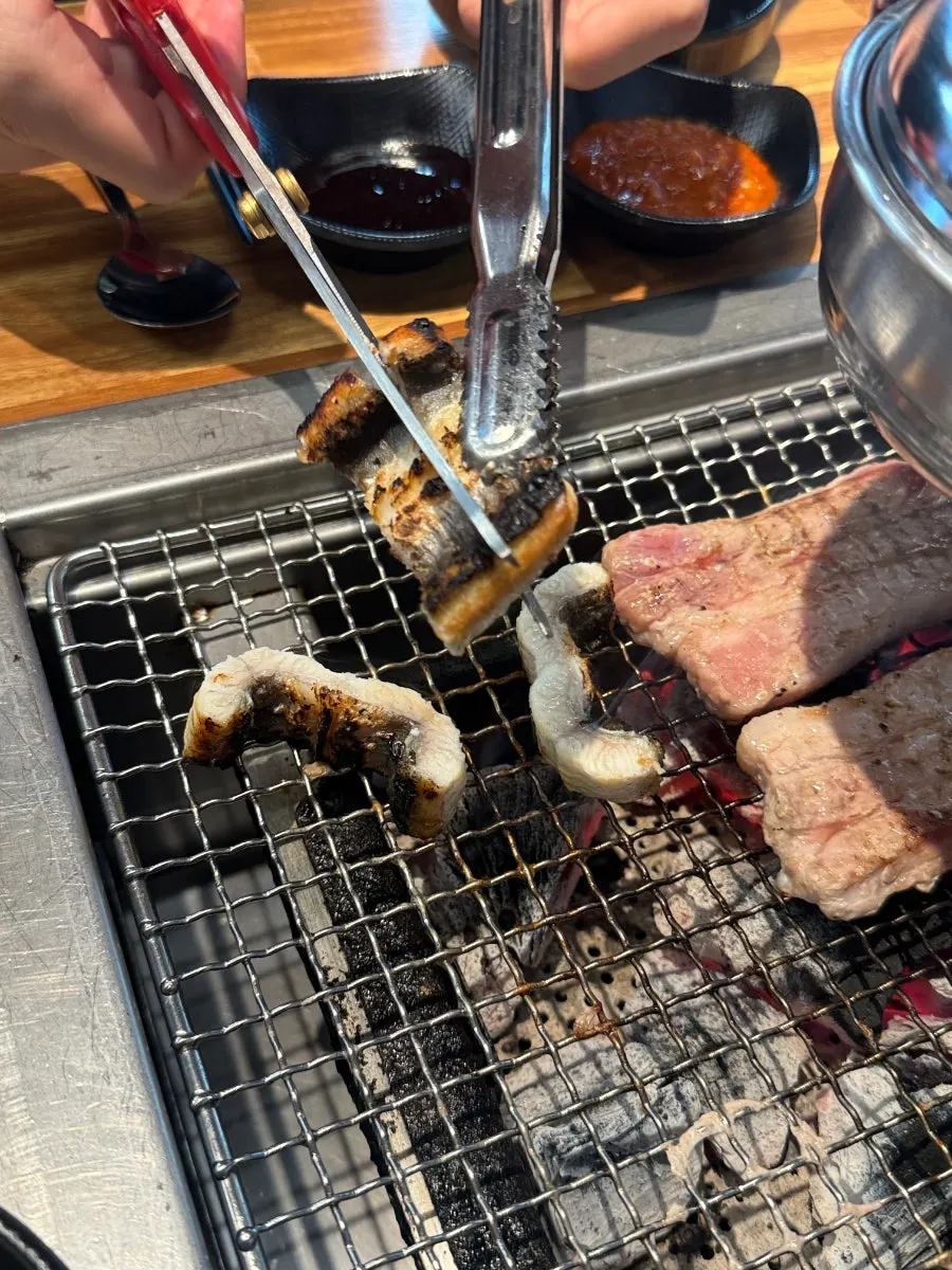 Freshwater eel grilling over charcoal