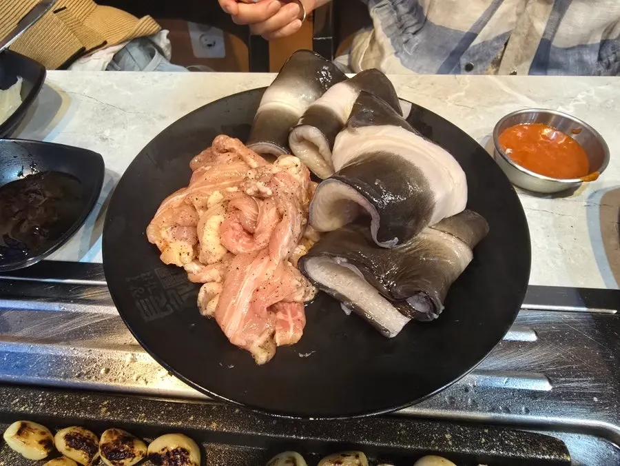 Freshwater eel and chicken neck meat on the grill