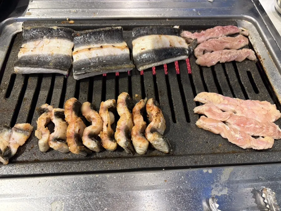 Full spread of unlimited eel with a glass of bokbunja wine