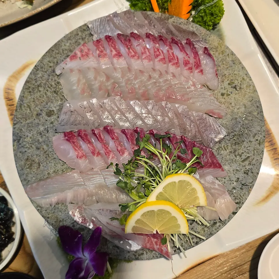 Mixed platter plated by fish type on a stone platter