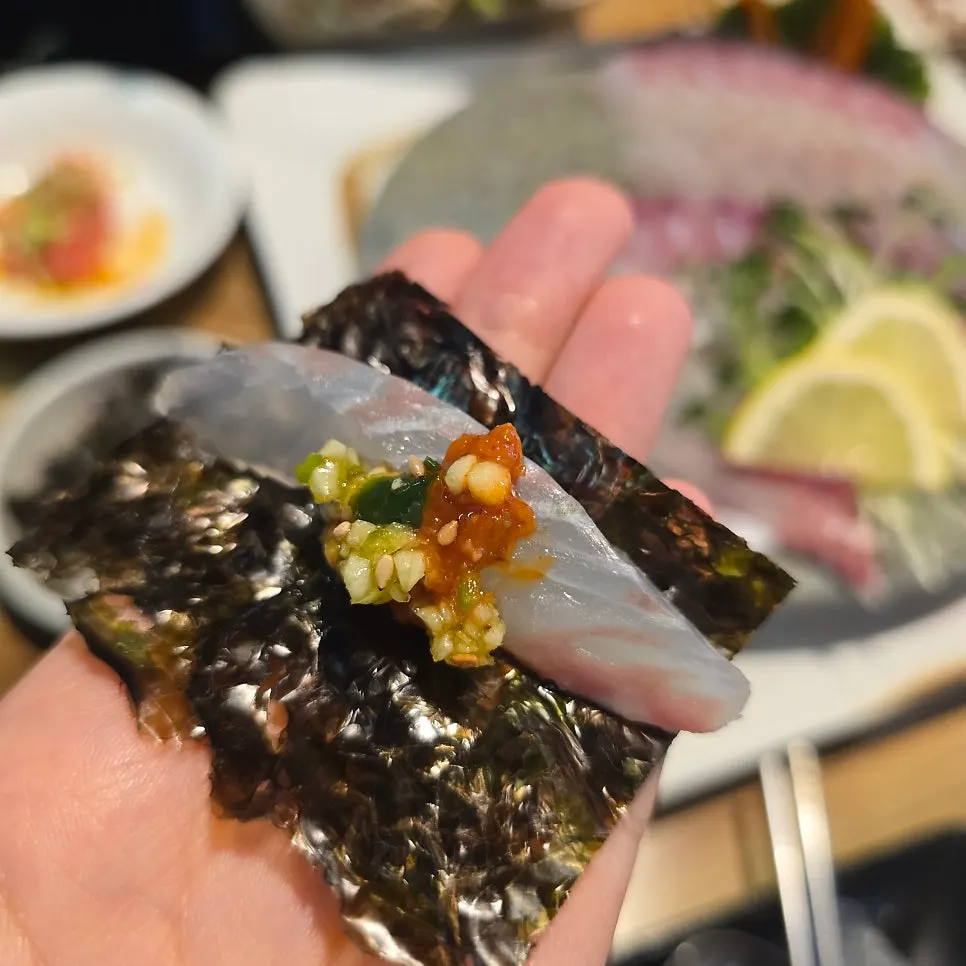 Raw fish paired with seasoning and sauce