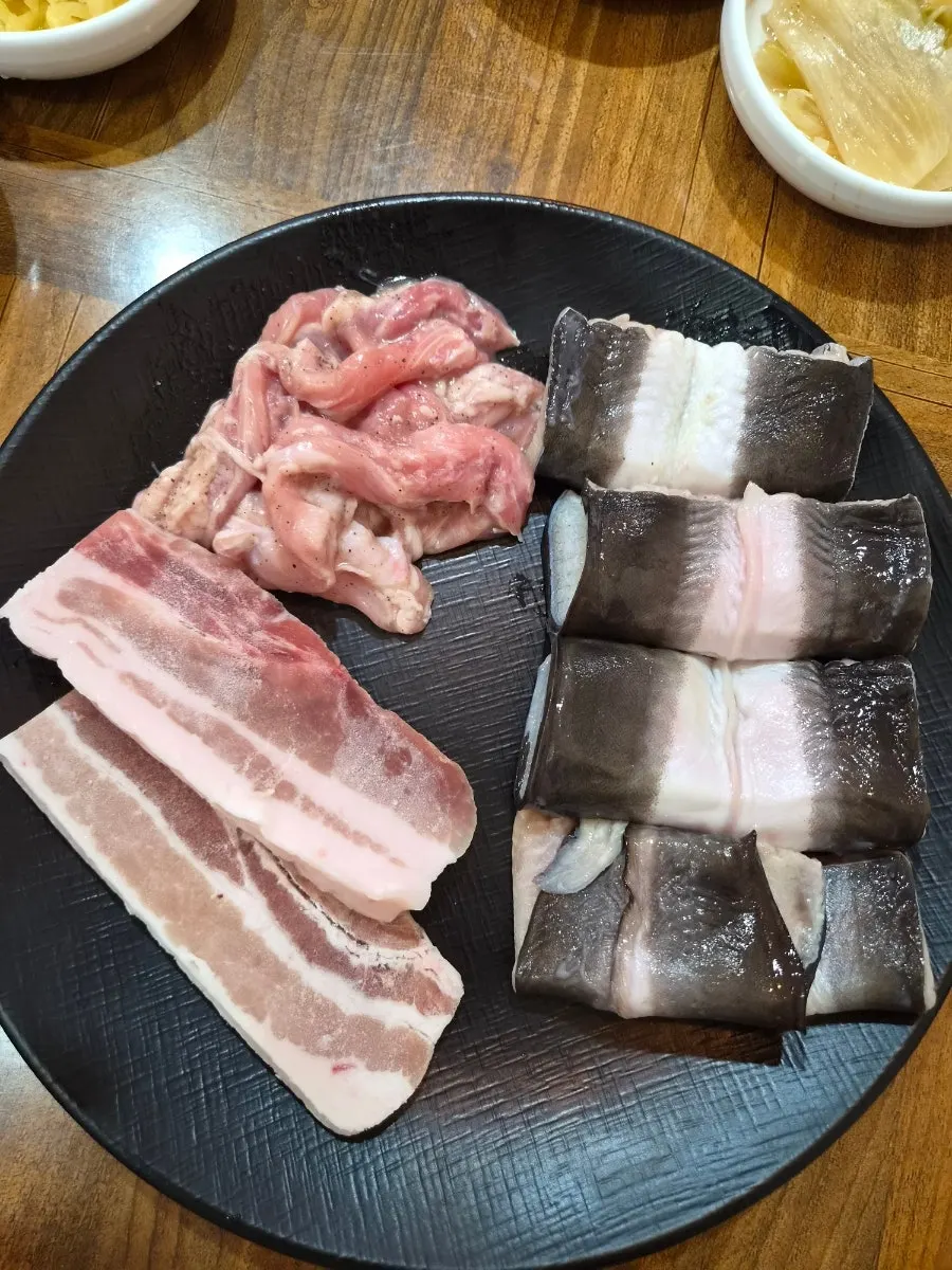 Basic table setting with freshwater eel, pork belly, and chicken neck meat