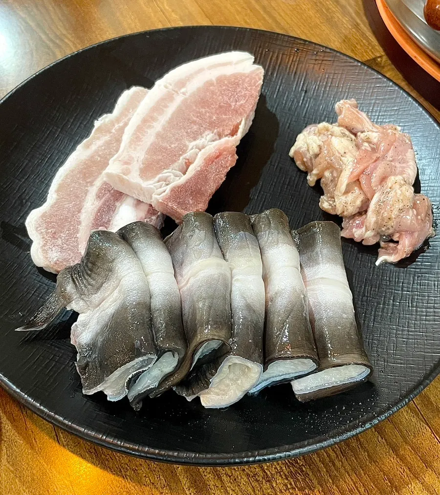A table served with eel, pork belly and chicken neck meat together