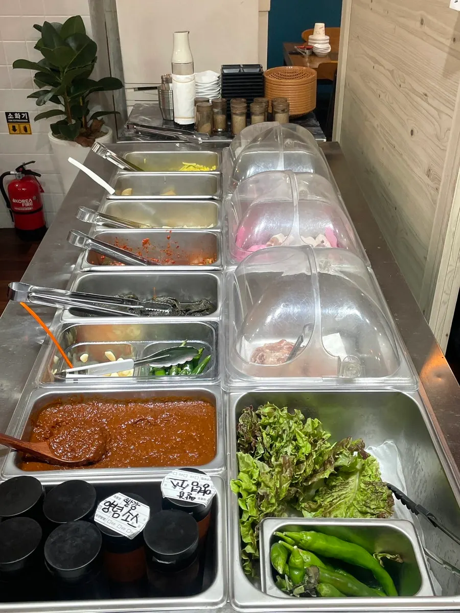 Self-bar stocked with vegetables, sauces and meat