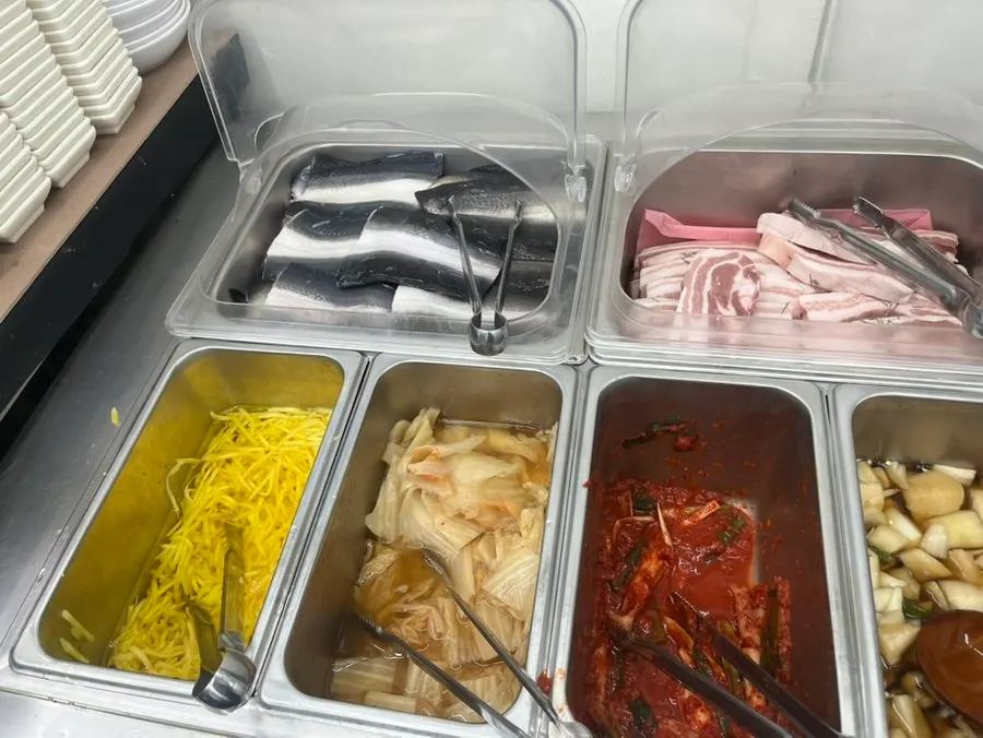 Vegetables and accompaniments arranged at the self-serve bar
