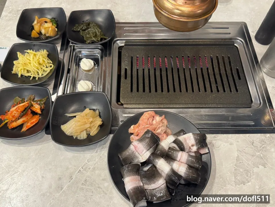 A full spread of basic side dishes, eel, and chicken neck meat