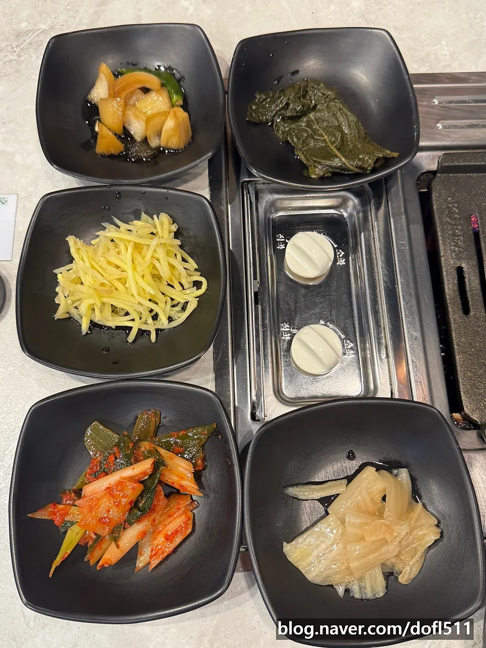 Plate of basic side dishes including ginger and aged kimchi