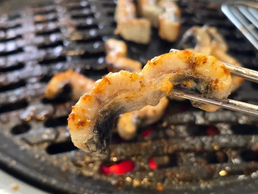 Picking up a piece of eel