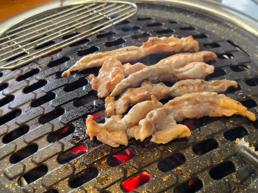 Chicken neck meat cooking on the grill