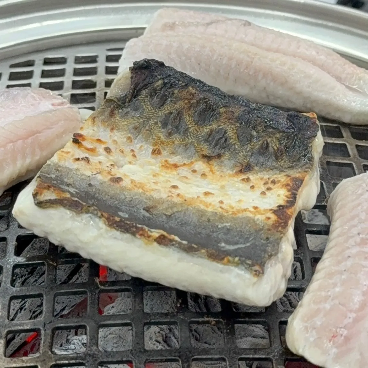 Freshwater eel grilling over charcoal