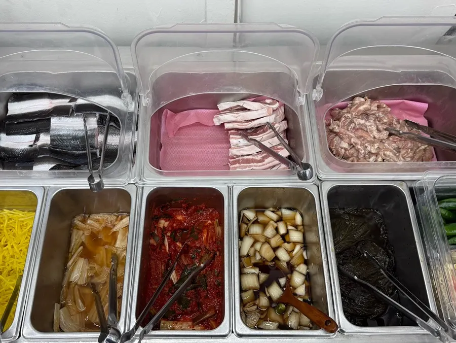 Self-serve bar with eel, pork belly and chicken neck laid out