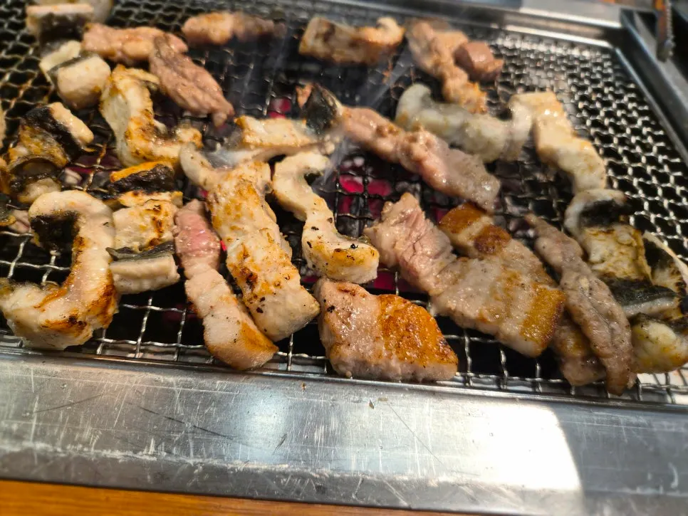 Eel cut into bite-sized pieces being grilled