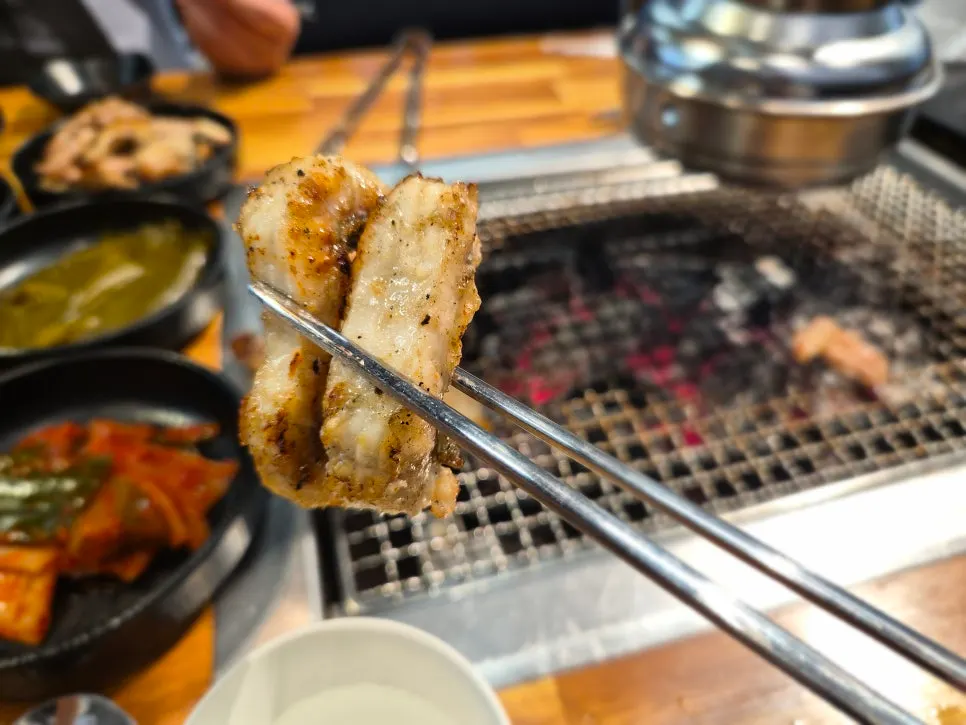 Eel and pork belly turning golden brown on the grill