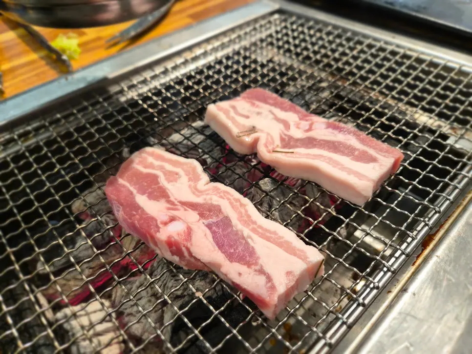 Close-up of eel and pork belly on the grill