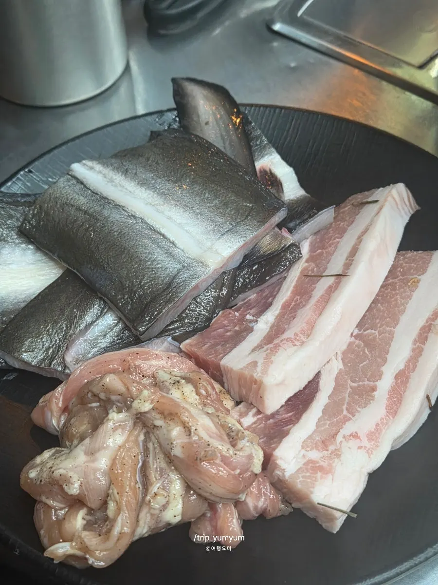 Plate of raw freshwater eel, pork belly, and duck neck