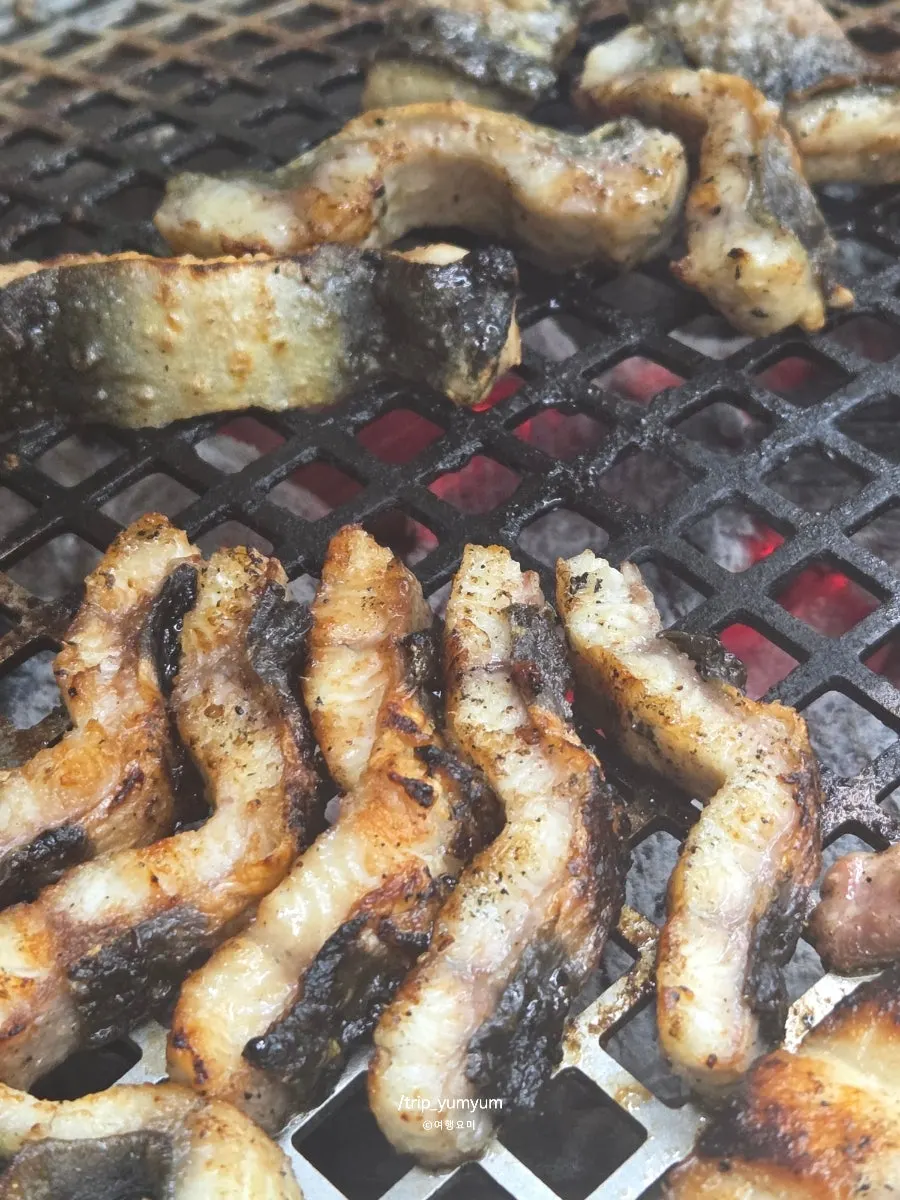 A glass of bokbunja wine with grilled meat