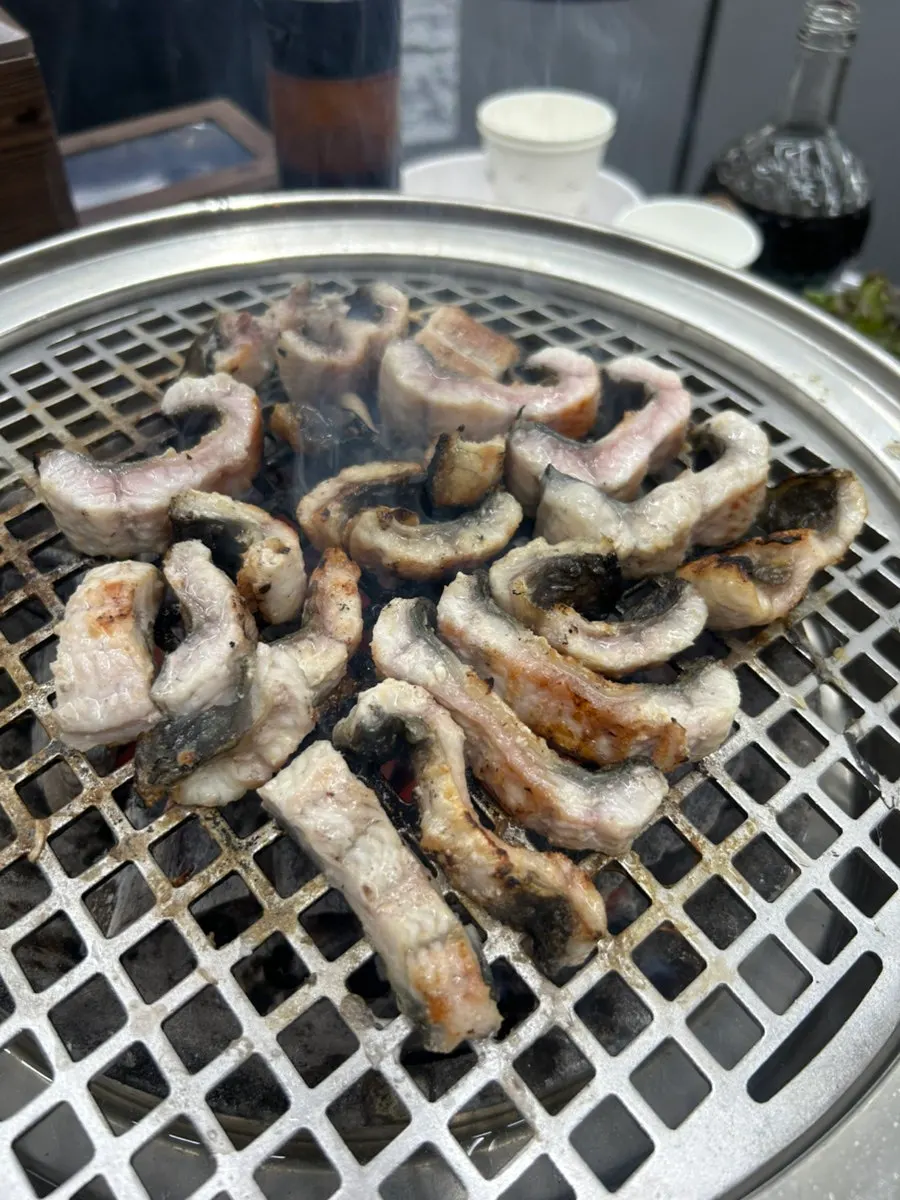 Plump freshwater eel grilled skin-side down on charcoal