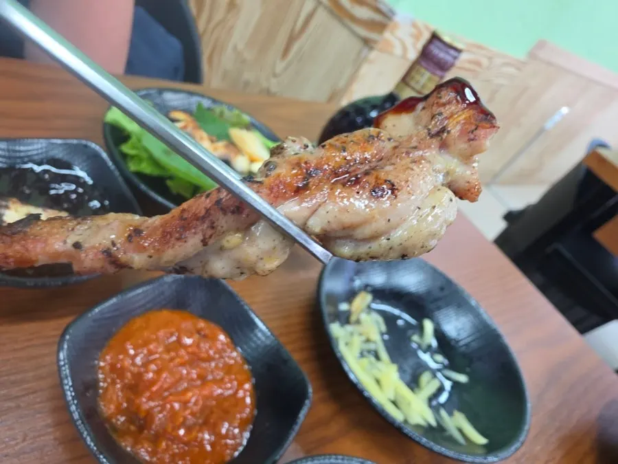 Chicken neck and pork belly grilling on the pan