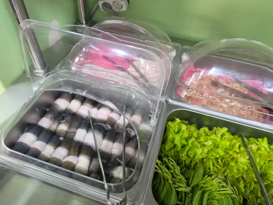 Self-serve bar with sides, vegetables, and eel