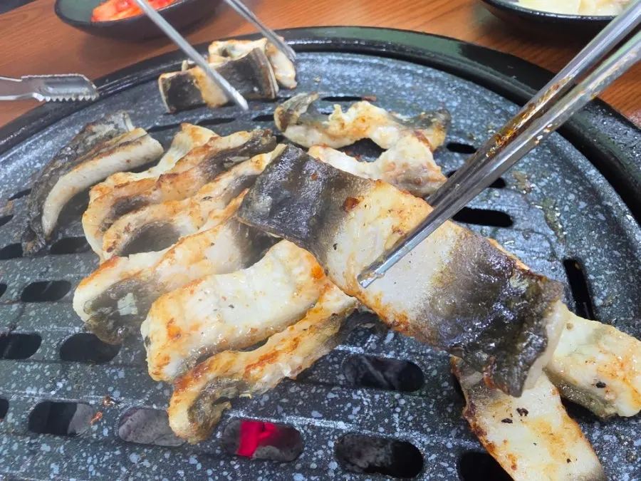 A piece of eel dipped in eel sauce