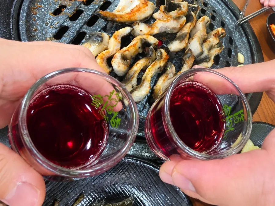 A glass of bokbunja wine paired with eel