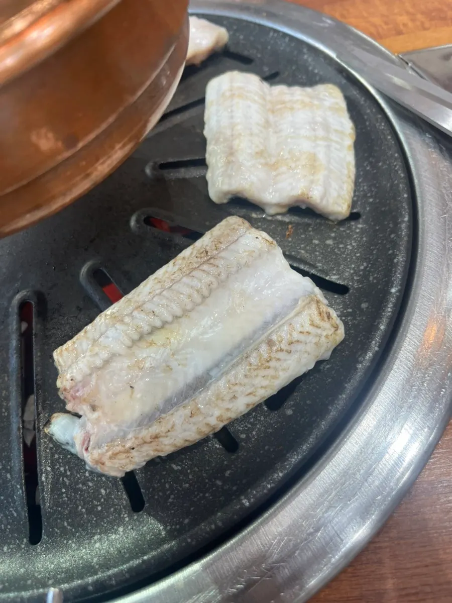 Eel placed back-up on the grill for cooking