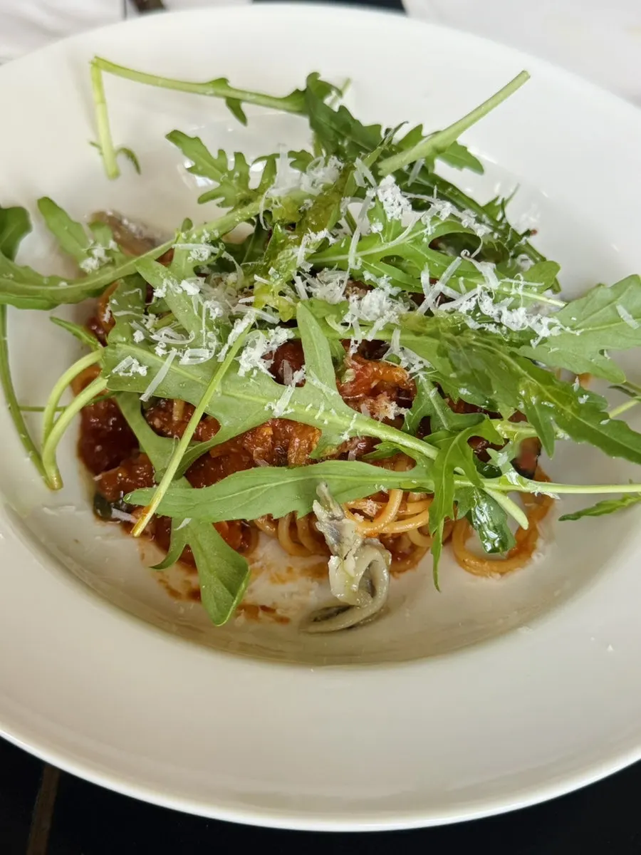 A plate of puttanesca pasta