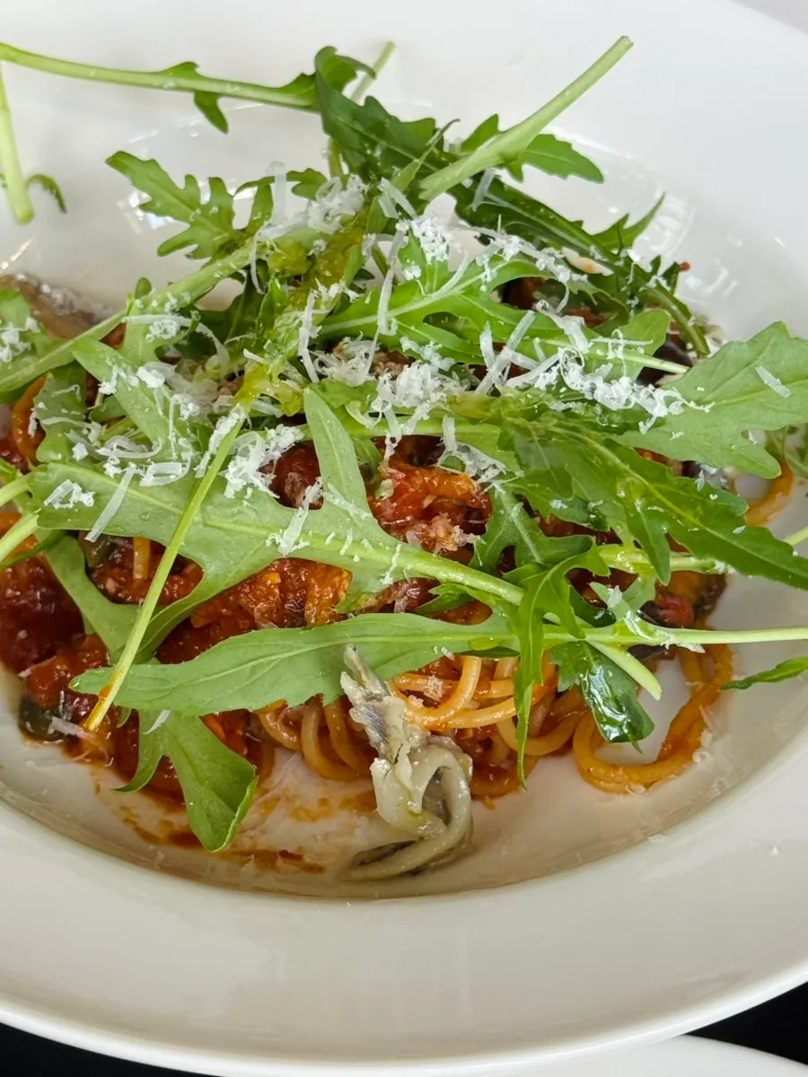 Close-up of the tomato-based puttanesca pasta