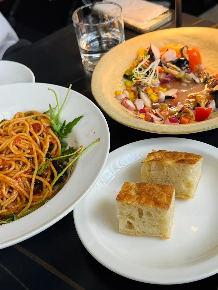 Serving out the puttanesca pasta