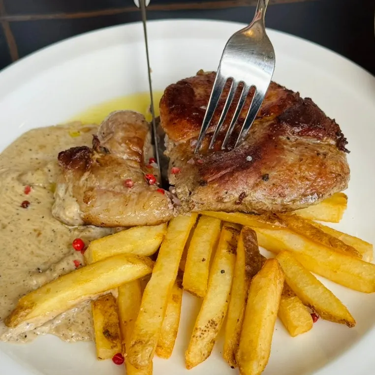 A large sous-vide pork neck steak
