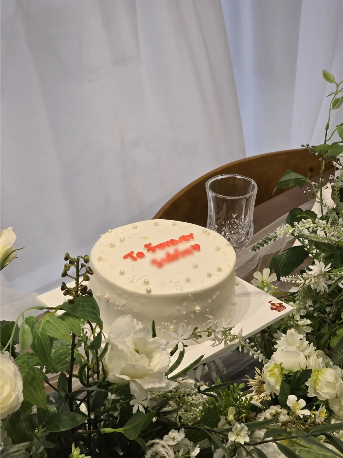 Bridal shower cake with white base and pink lettering