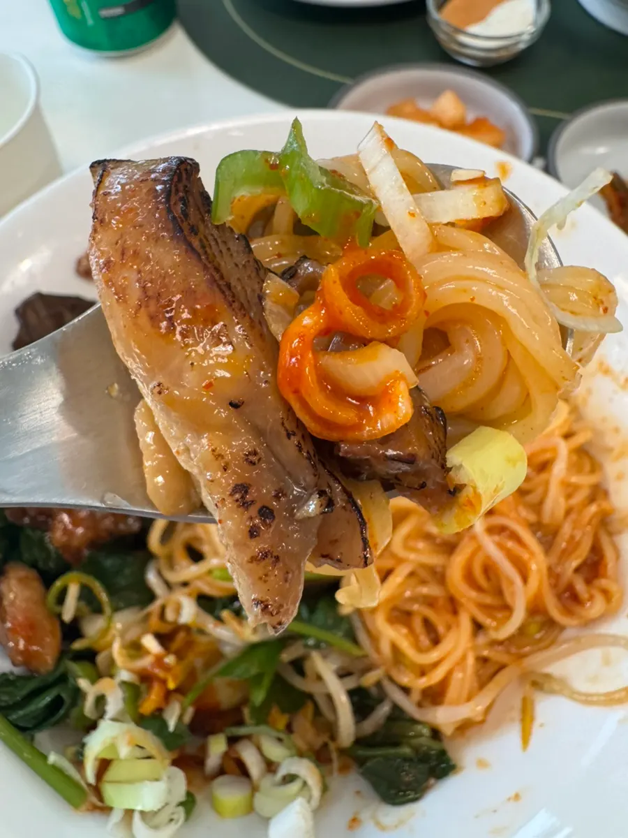 A piece of char siu with the bibim noodles