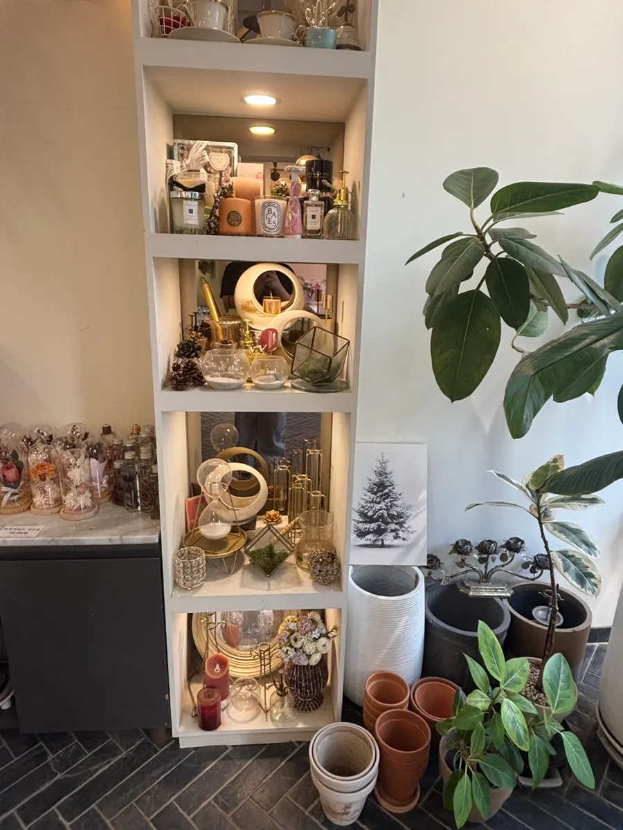 Neatly organized flower shop display shelves