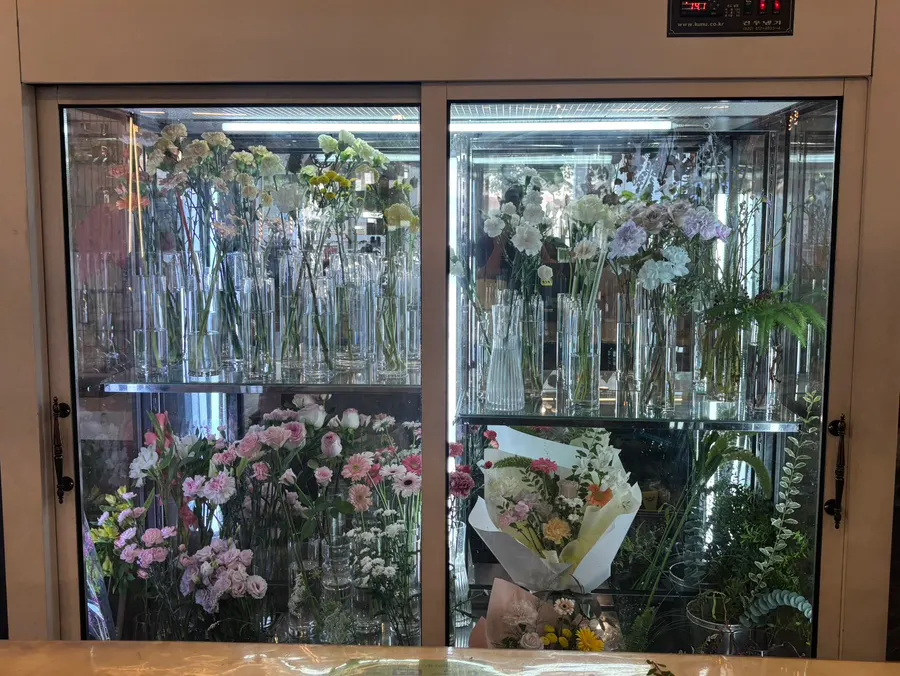 Display shelf with various fresh flowers