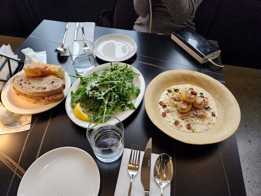 Table set with arugula salad and mushroom cream potato gnocchi