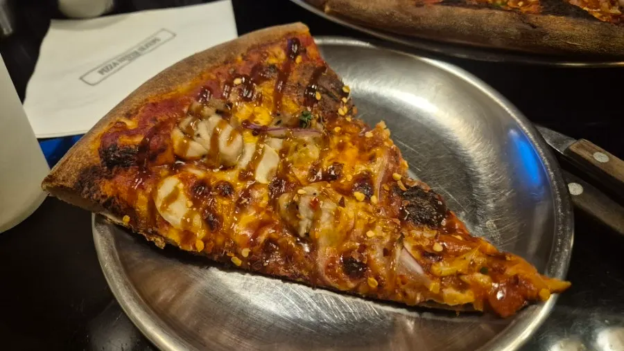 A slice of pizza with Tabasco