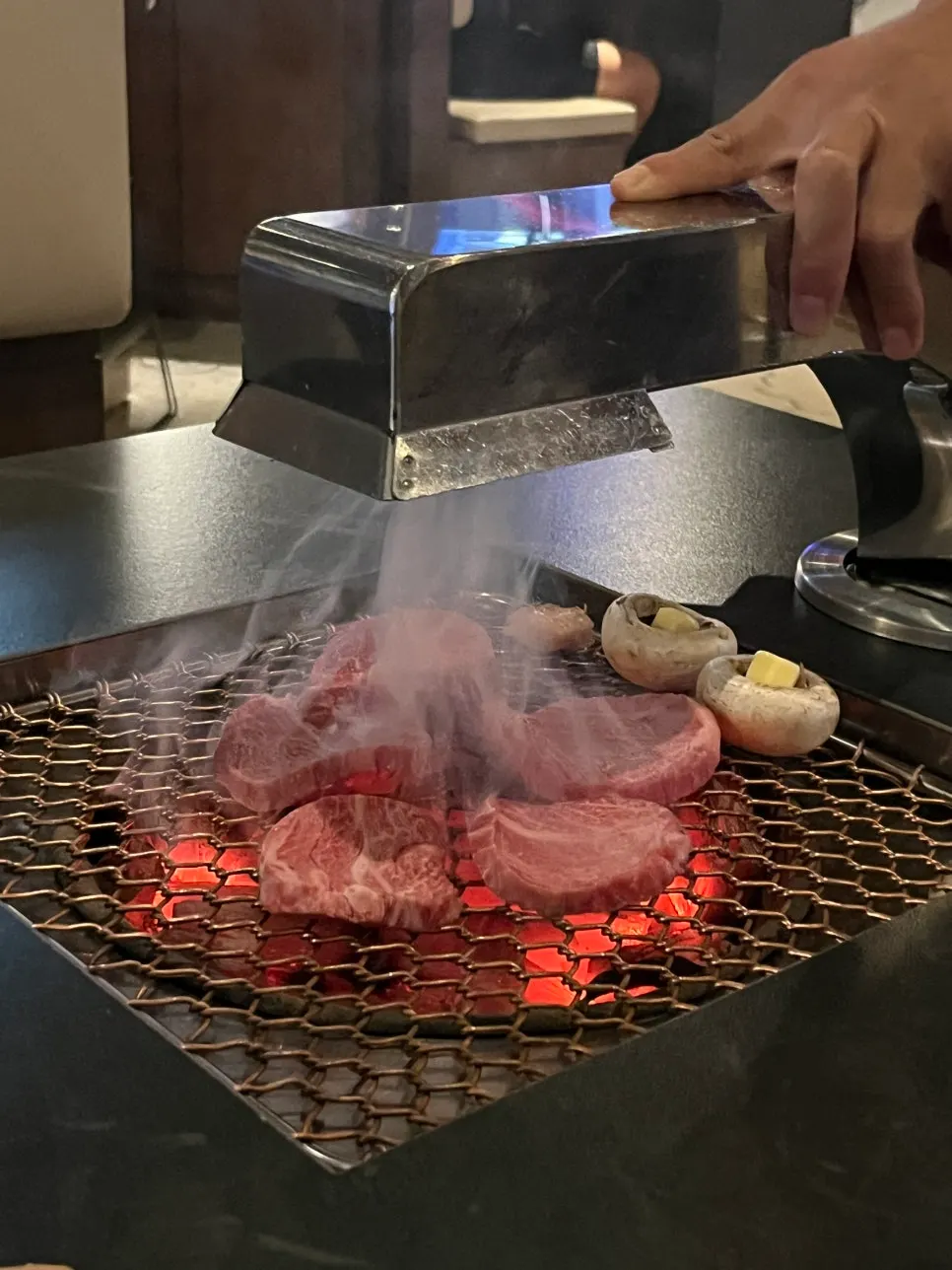 Sirloin and buttered mushrooms placed on the charcoal grill