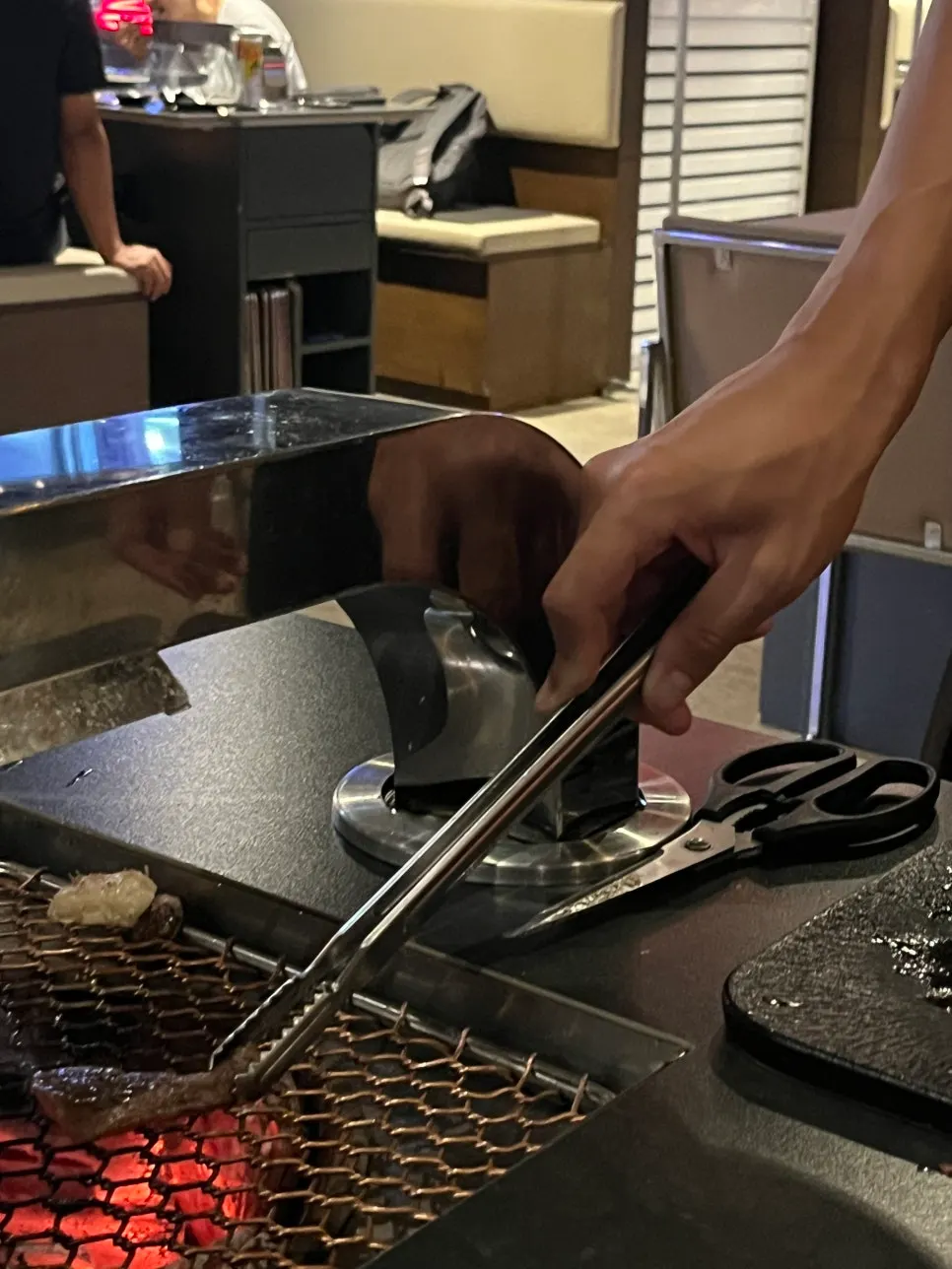 A server grilling the sirloin directly at the table