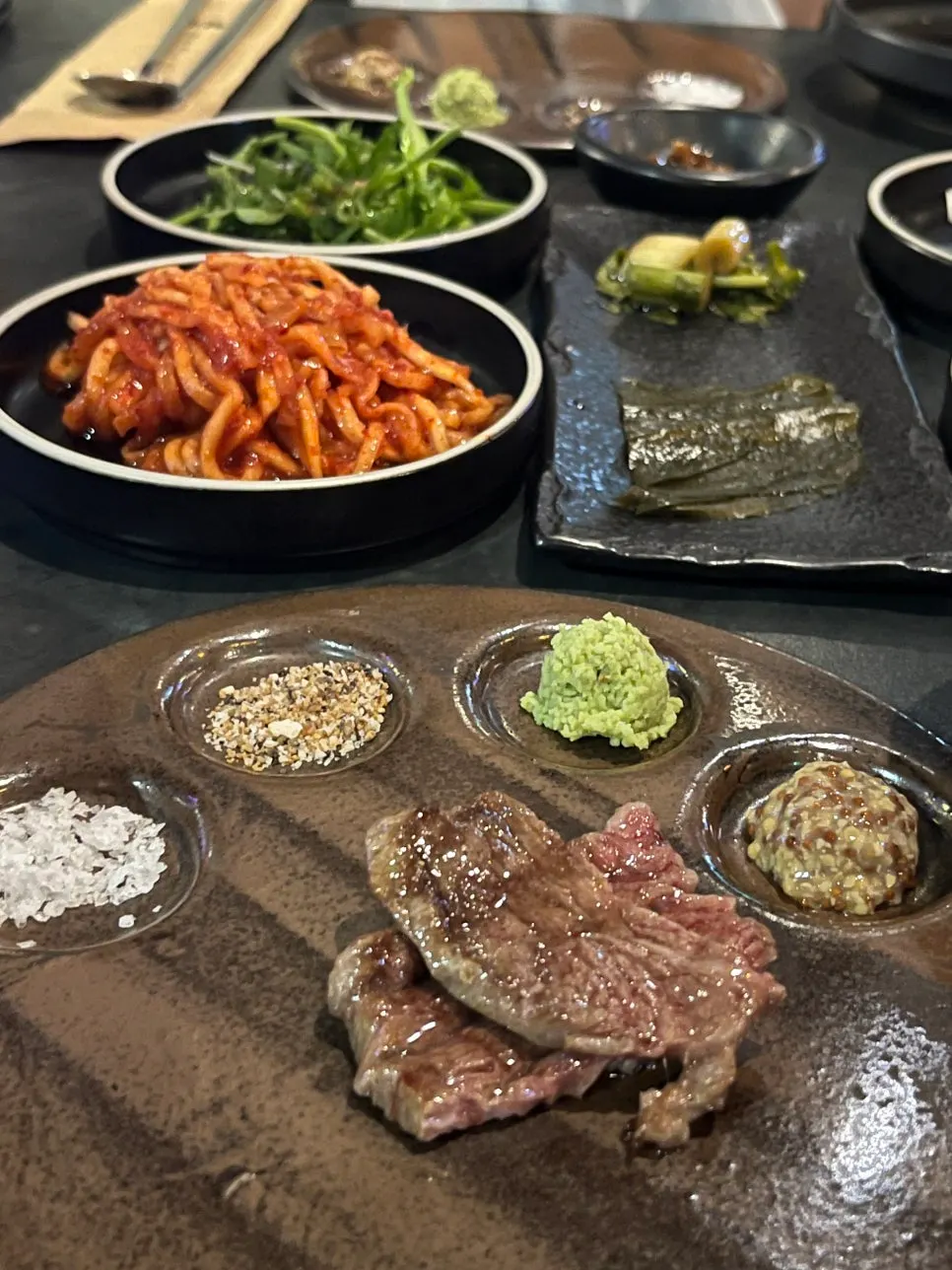A piece of sirloin served with salt and wasabi