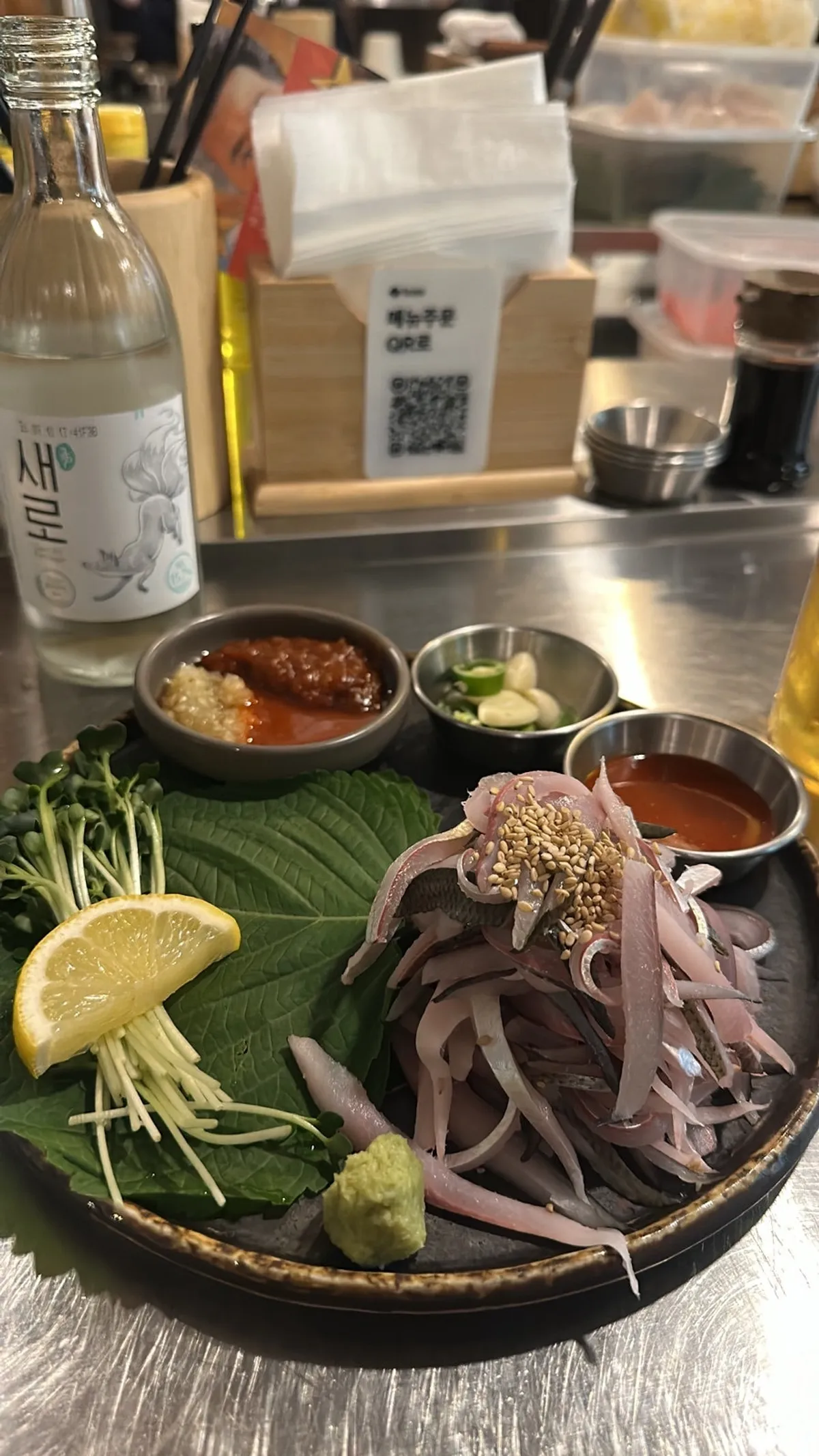 A fall evening spread of gizzard shad sashimi with a glass of soju