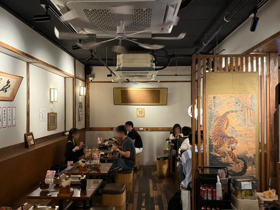 Tiger scroll painting and framed art on the wall