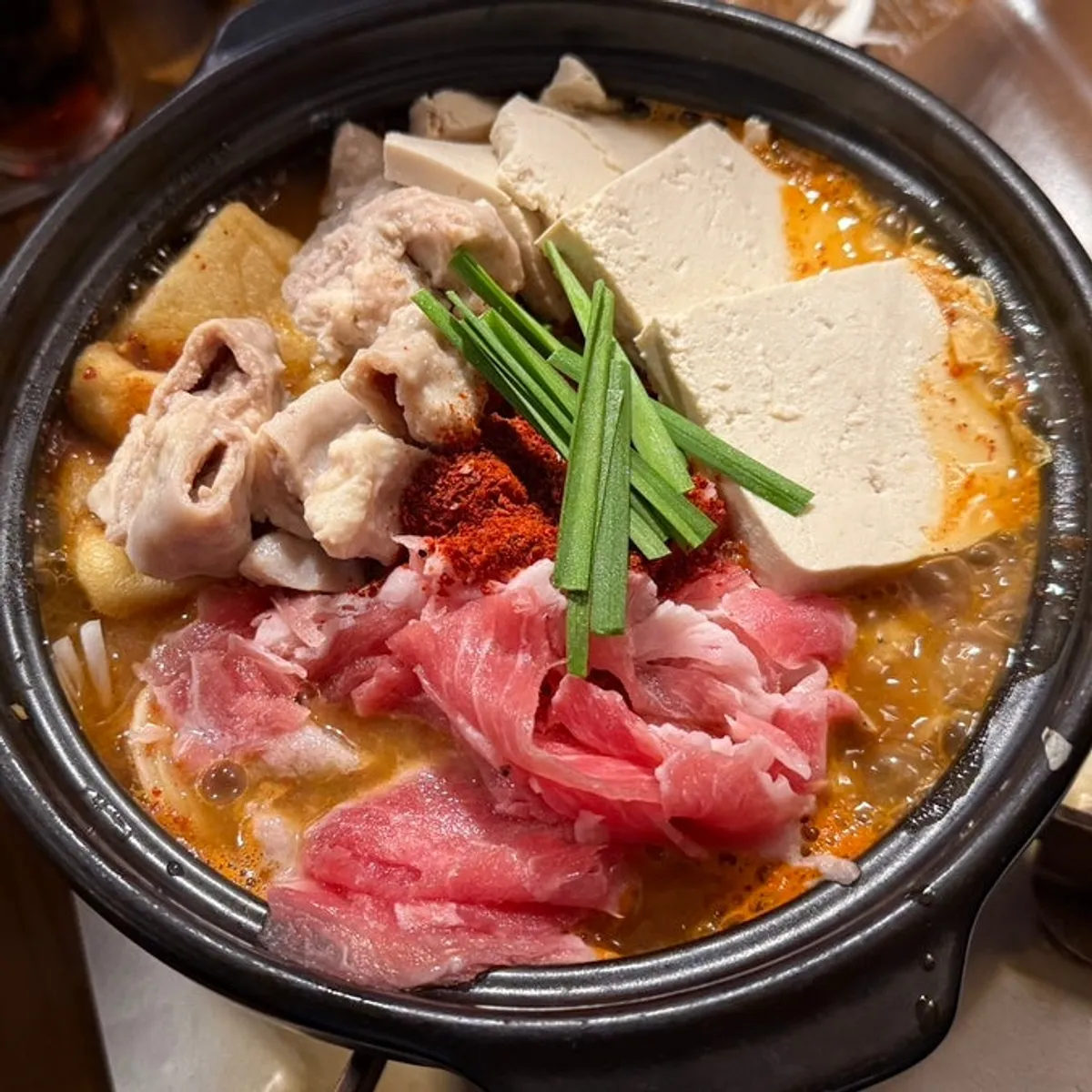Close-up of the beef gopchang hot pot with rich broth boiling